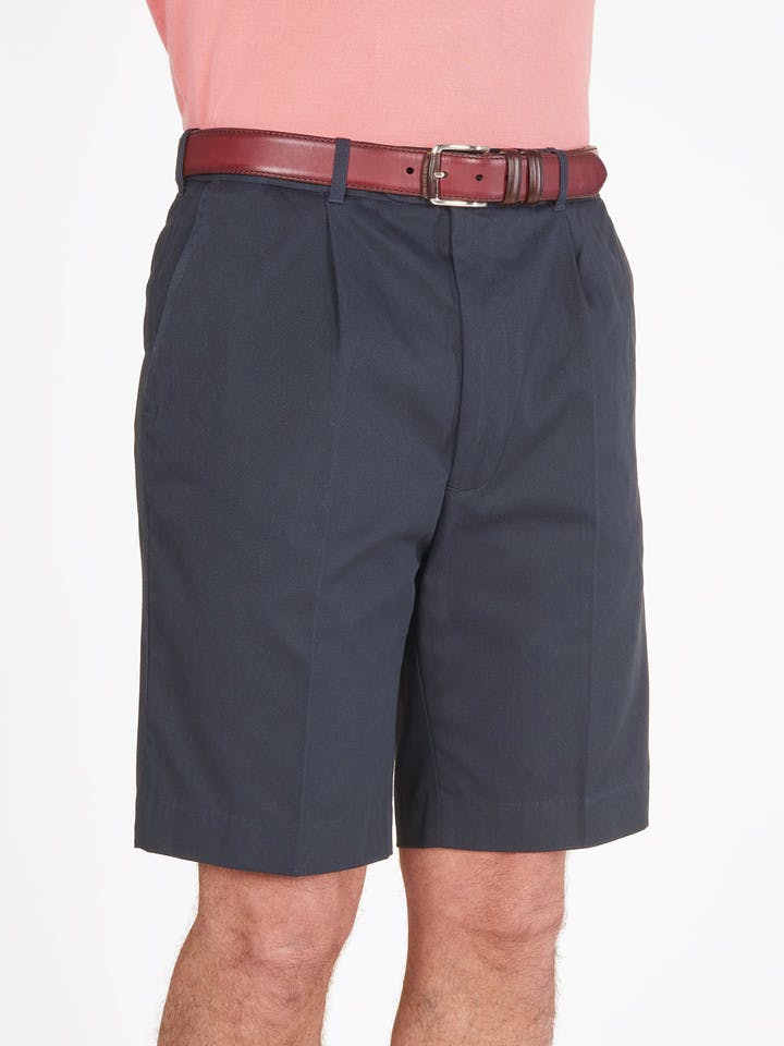 Model wears Men's Navy Blue Cotton Pleated Dress Shorts